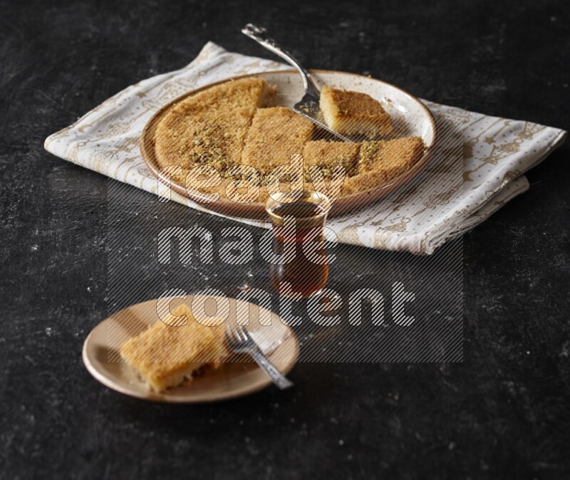 konafa with tea in a dark setup
