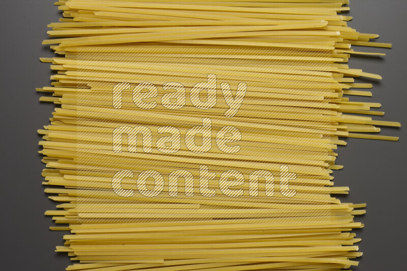 Linguini pasta on grey background