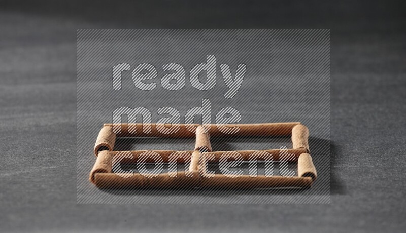 4 squares of cinnamon sticks on black flooring