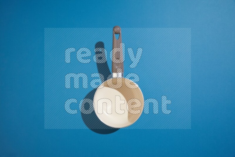 white pan on blue background