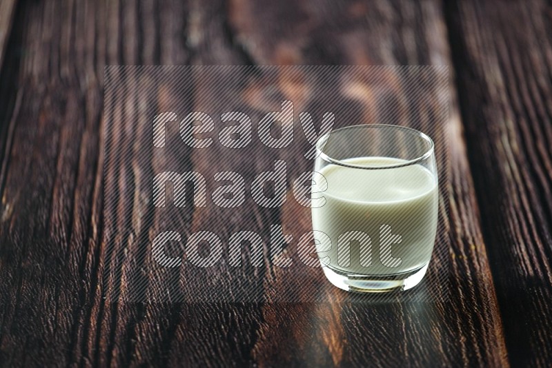 Cold drinks in a glass cup such as water, tamarind, qamar eldin, sobia, milk and hibiscus on wooden background