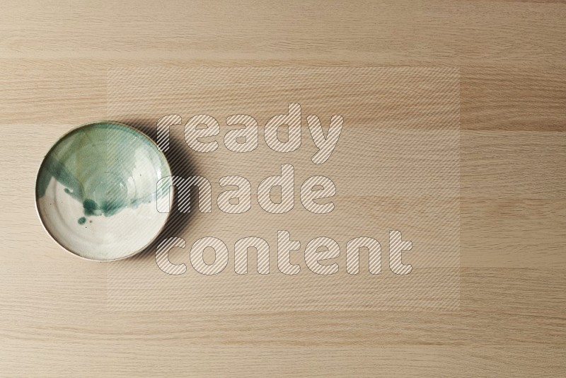 Top View Shot Of A Multicolored Pottery Plate on Oak Wooden Flooring