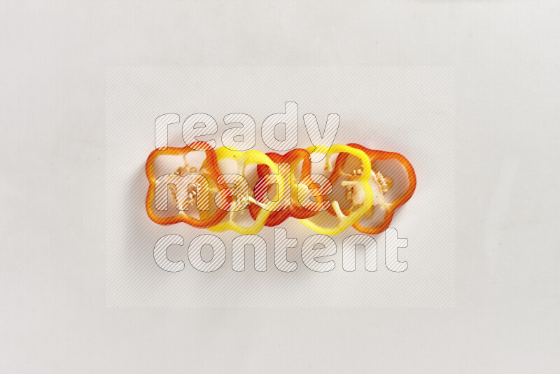 Assorted bell pepper slices on white background