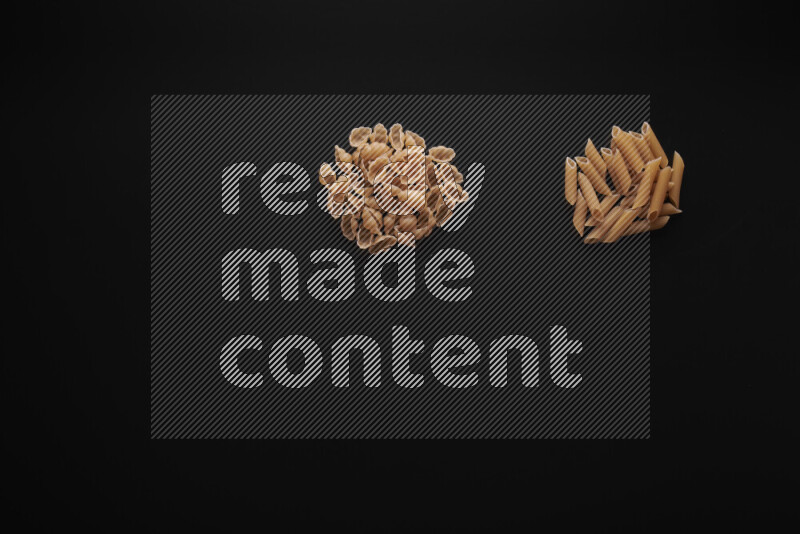 Different pasta types in bunches on black background