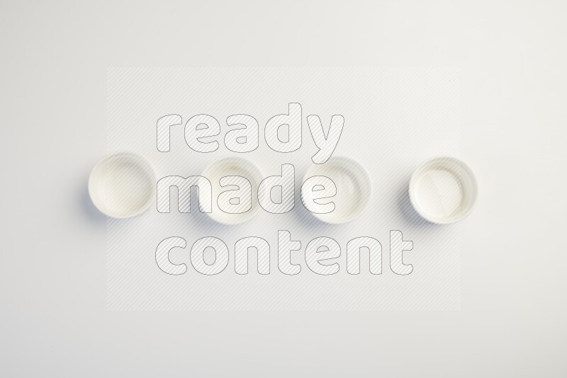 white ceramic round sauce dish on white countertop