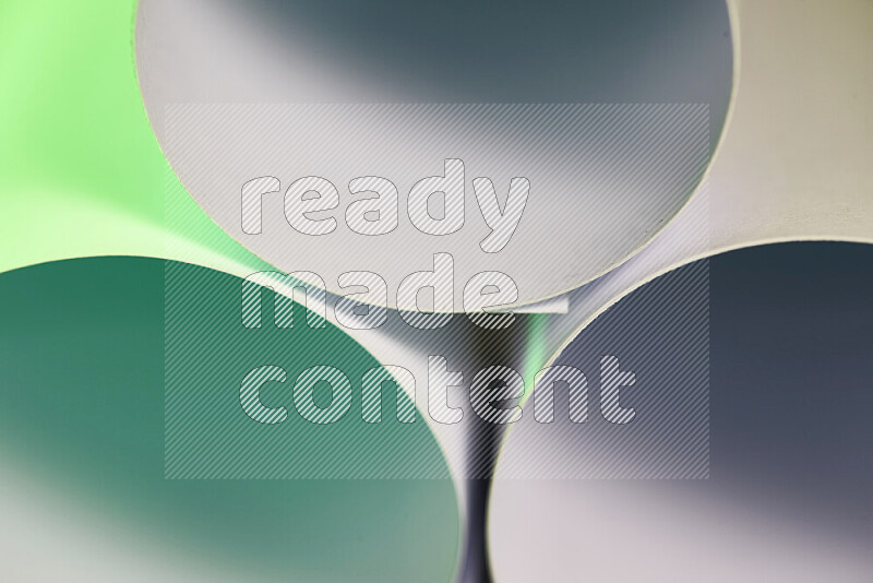The image shows an abstract paper art with circular shapes in varying shades of green