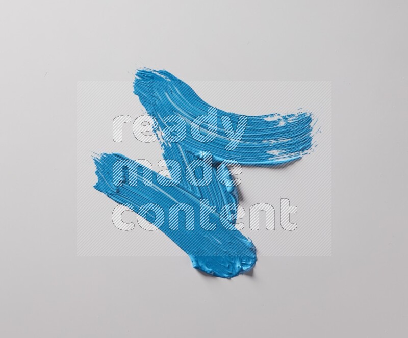 Multi blue curved brush strokes shaped into different shapes on a white background