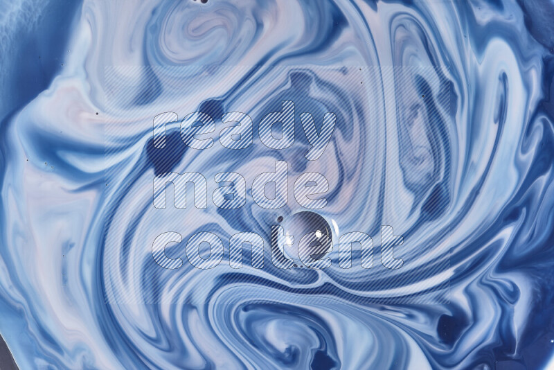 A close-up of abstract swirling patterns in blue, red and white