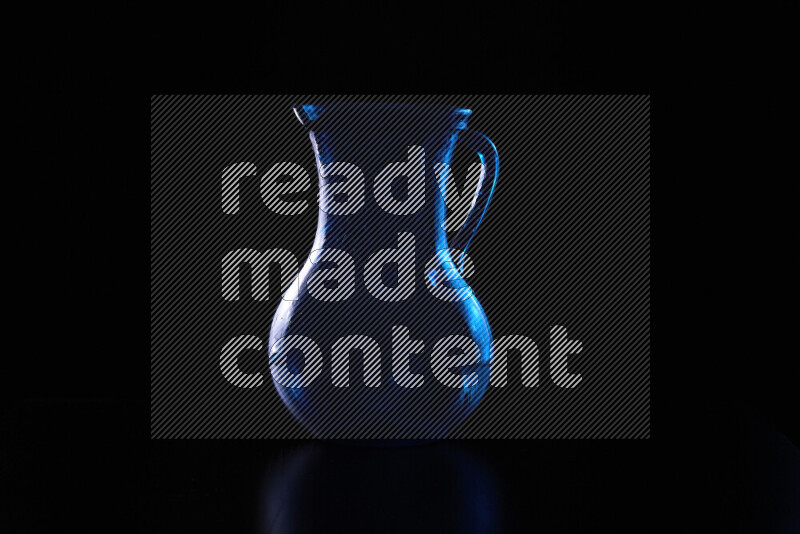 Glassware with rim light in blue and white against black background