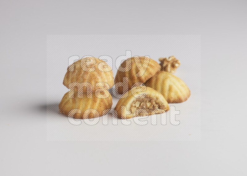 Five Pieces of Maamoul filled with walnut paste  one of them is cut with direct on white background