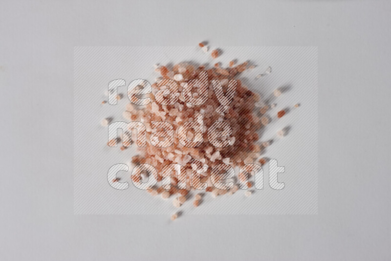 A bunch of coarse himalayan salt crystals on white background