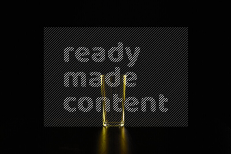 Glassware with rim light in yellow against black background