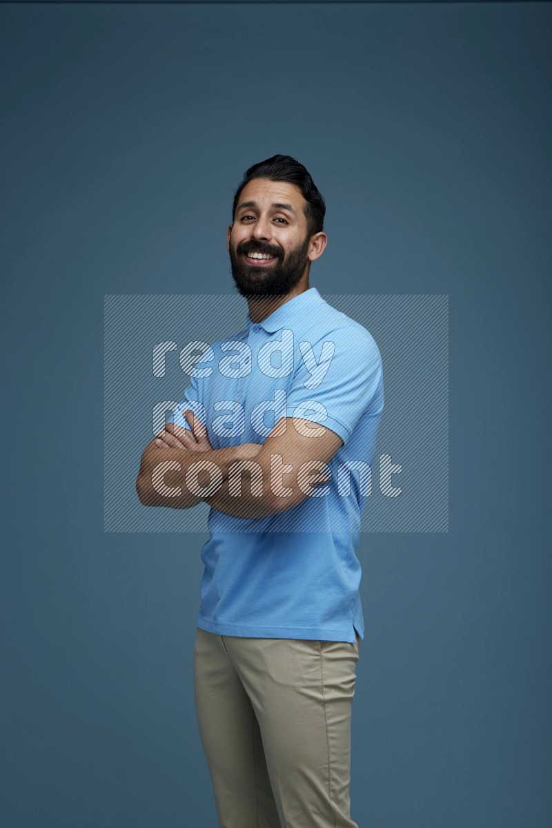 Man posing in a blue background wearing a Blue shirt