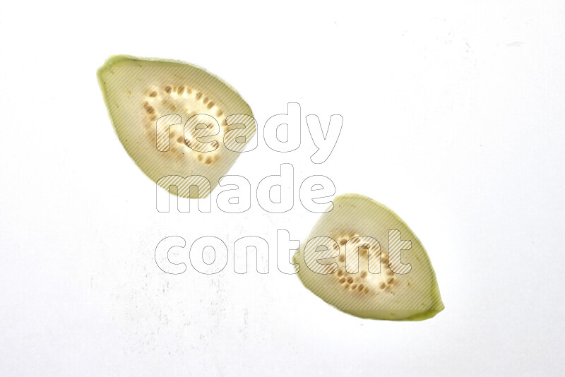 Guava slices on illuminated white background