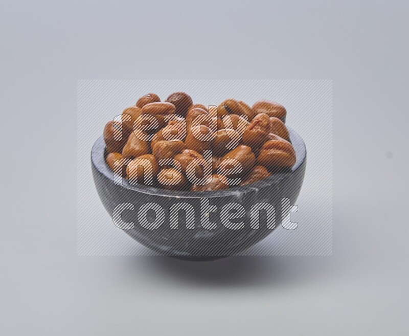 Close up shot of cooked fava beans (foul) in a container on white background