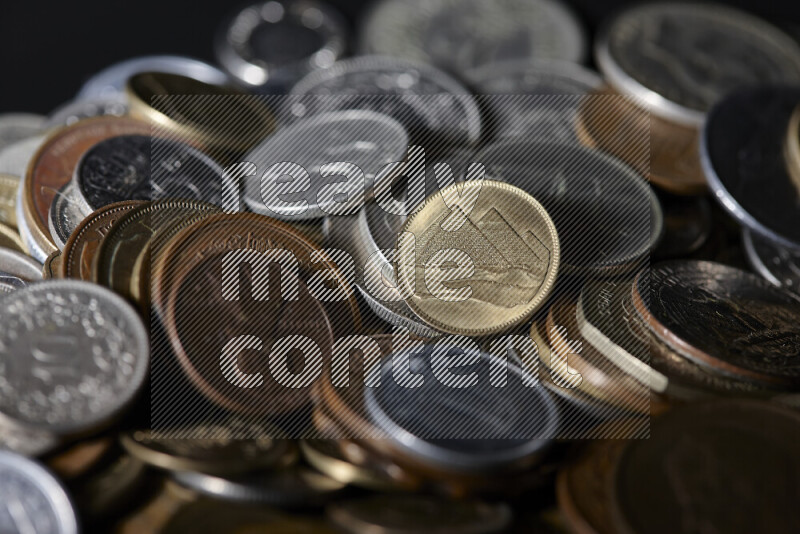 A close-ups of random old coins on black background