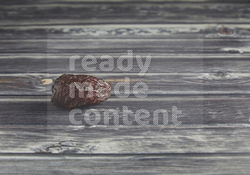 one madjoul date on a wooden grey background