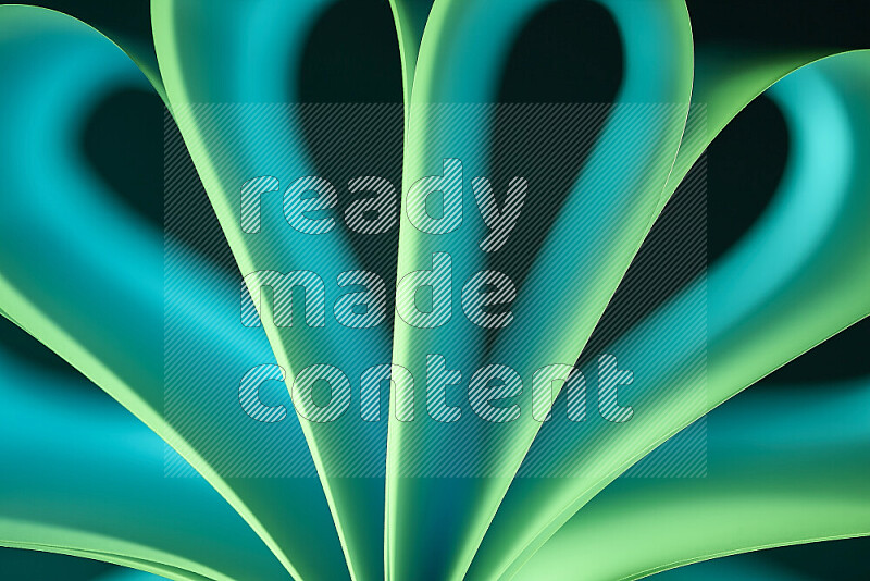 An abstract art piece displaying smooth curves with green gradients created by colored light