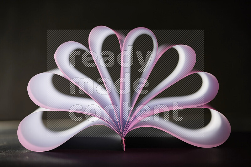 An abstract art piece displaying smooth curves in pink and white gradients created by colored light