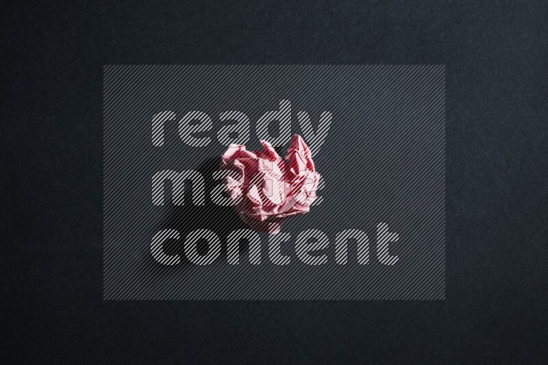 Pink paper sheet on black background