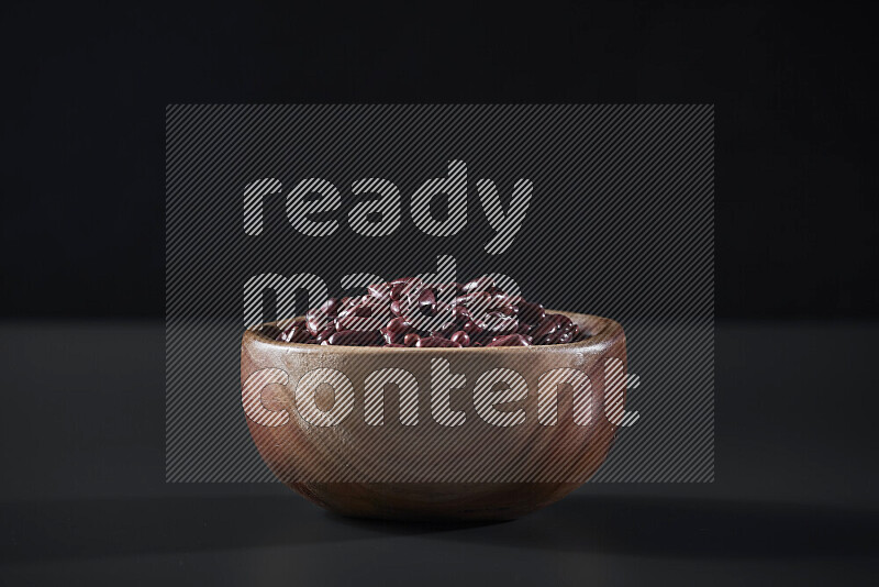 Red kidney beans in a wooden bowl on grey background