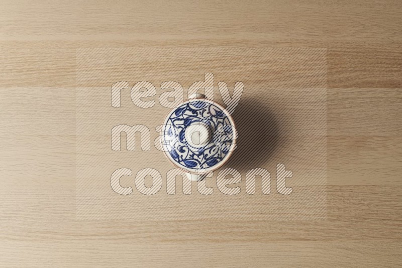 Top View Shot Of A Multicolored Pottery Pot on Oak Wooden Flooring