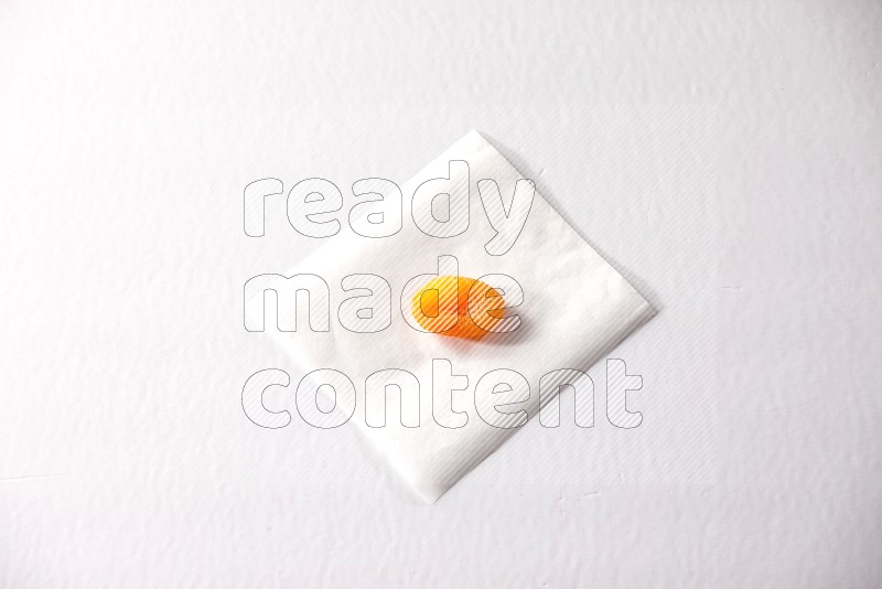 A dried apricot on a piece of paper on a white background in different angles