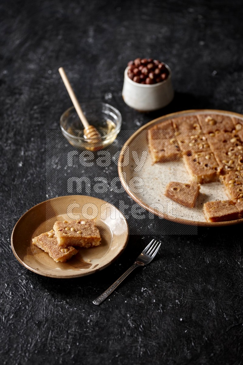 Basbousa with nuts and honey in a dark setup