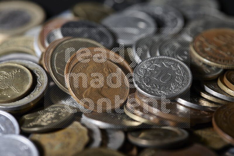 A close-ups of random old coins on black background