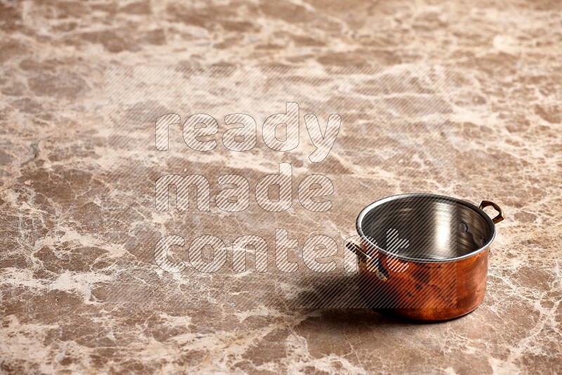 Small Copper Pot on Beige Marble Flooring, 45 degrees