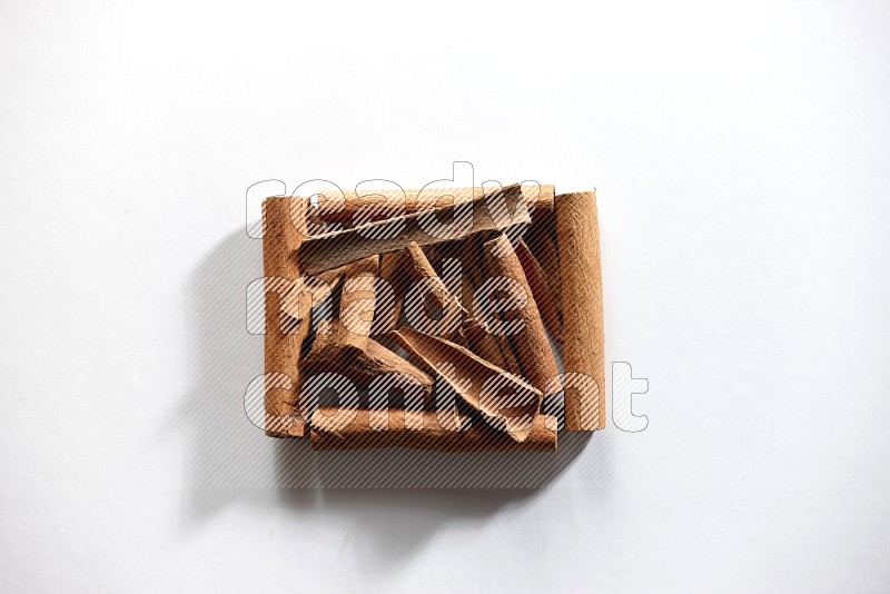 A single square of cinnamon sticks full of cinnamon on white flooring