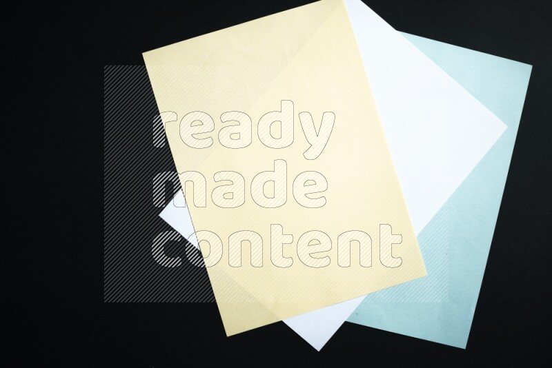 Multicolored paper sheet on black background