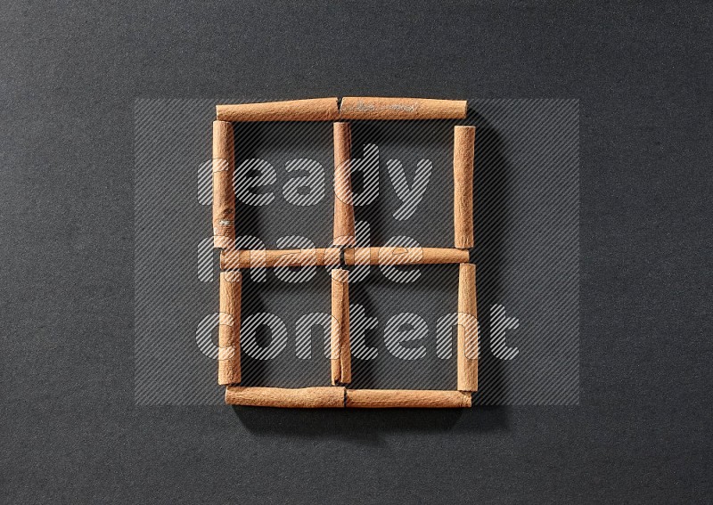 4 squares of cinnamon sticks on black flooring