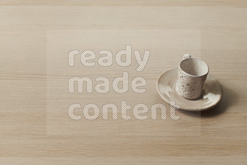 A pottery cup on light wooden background