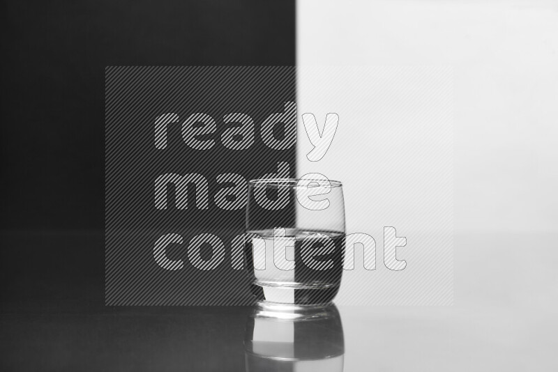 The image features a clear glassware filled with water, set against white and black background