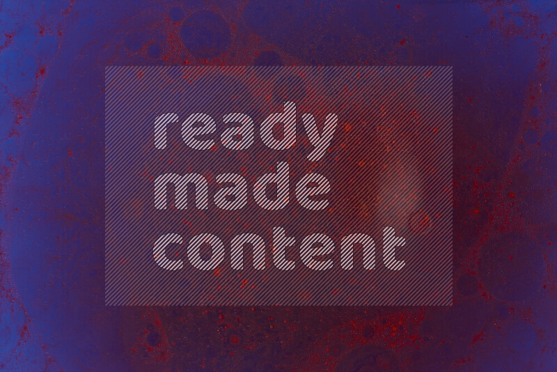 The image captures a dramatic splatter of red paint over a blue backdrop