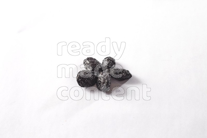 Dried plums on white background