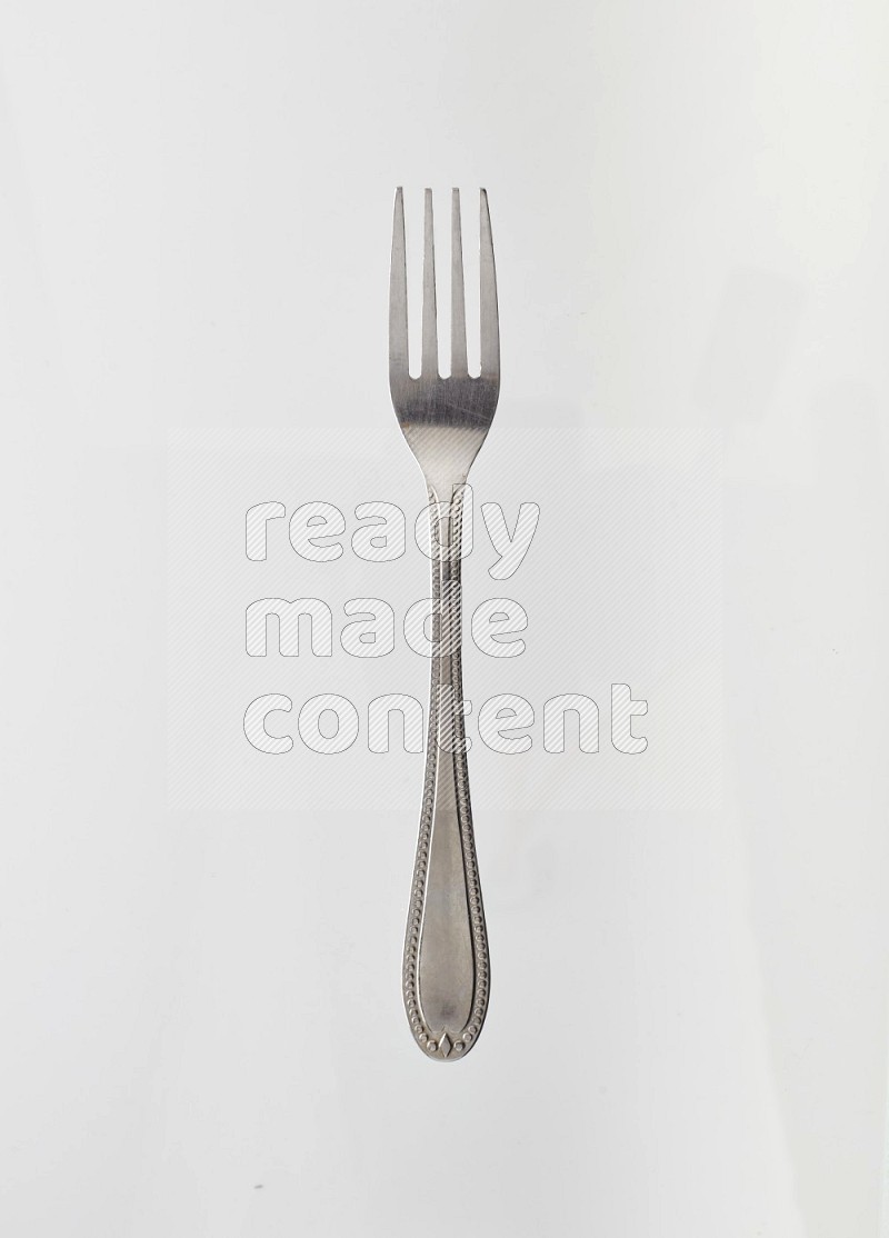 Silver stainless steel fork on white background