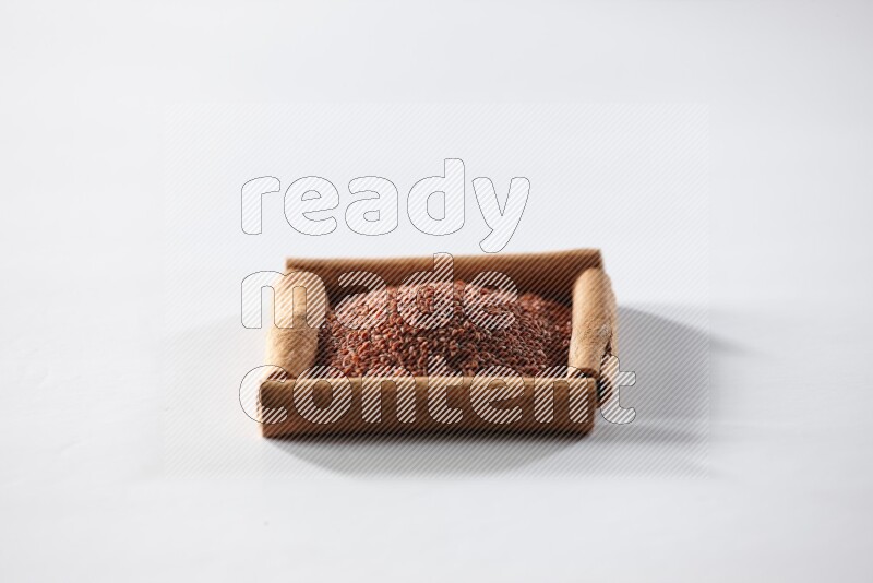A single square of cinnamon sticks full of garden cress on white flooring