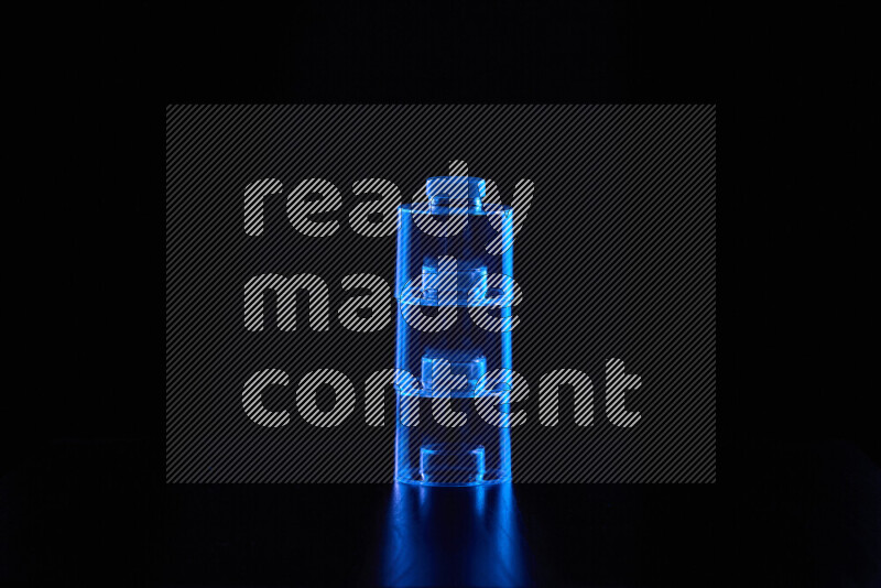 Glassware with rim light in blue against black background