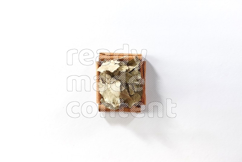 A single square of cinnamon sticks full of laurel bay on white flooring