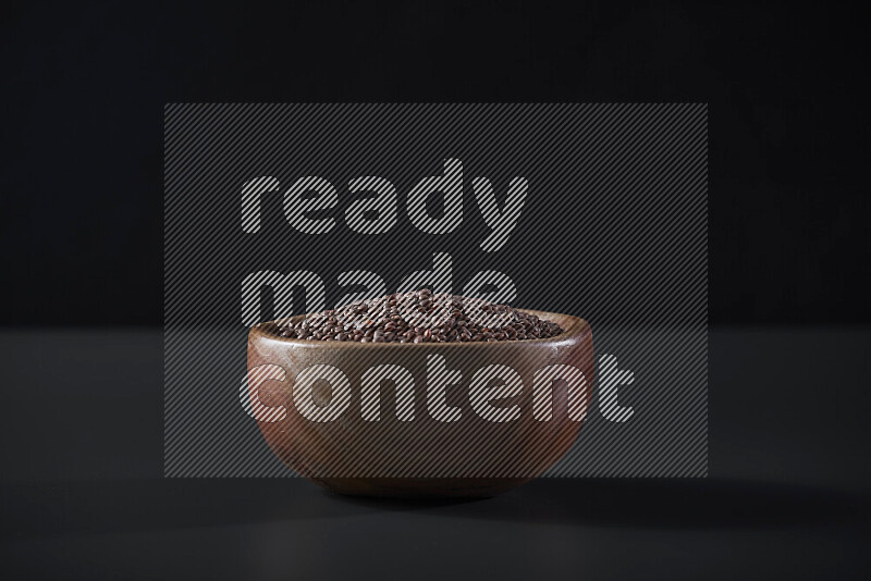 Brown lentils in a wooden bowl on grey background