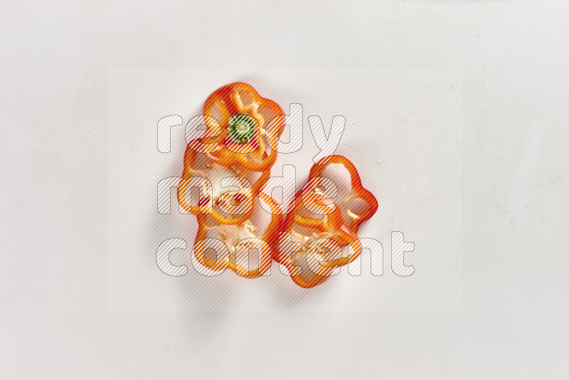 Red bell pepper slices on white background