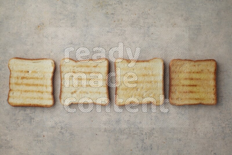 Toasted white Toast slices on a light blue textured background