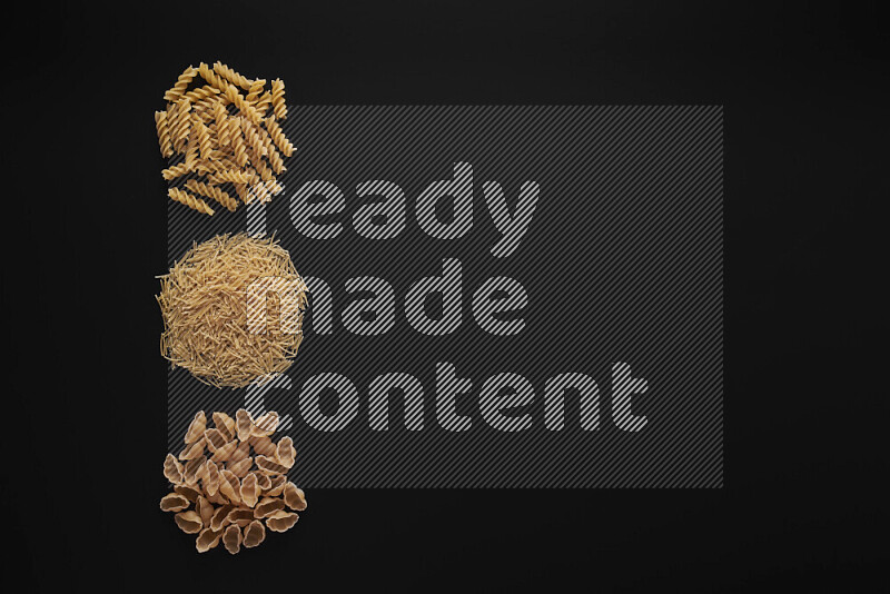 Different pasta types in 3 bunches on black background