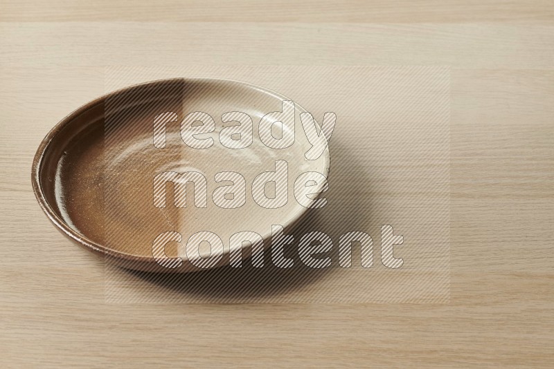 Multicolored Pottery Plate on Oak Wooden Flooring, 45 degrees