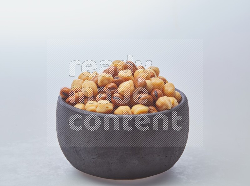 Close up shot of cooked fava beans (foul) & chickpeas on white background