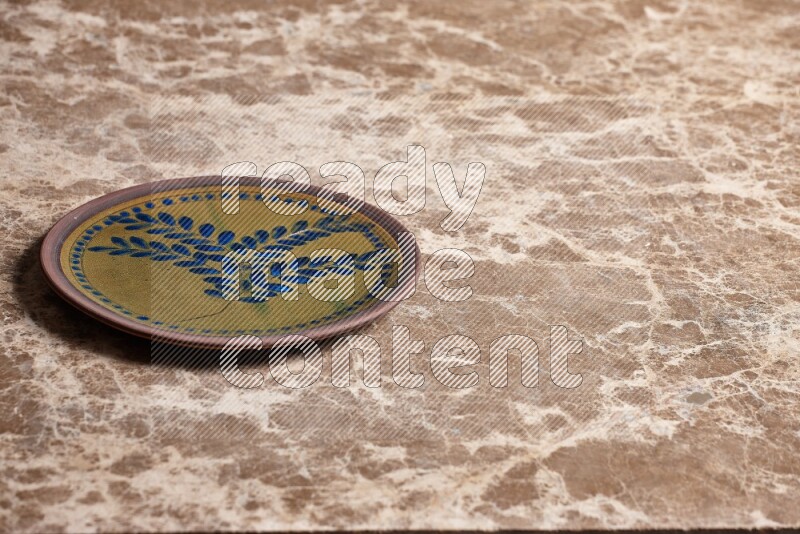 Decorative Pottery Plate on Beige Marble Flooring