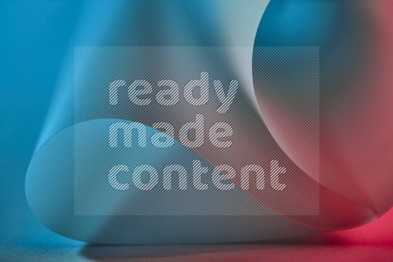 An abstract art piece displaying smooth curves in blue and red gradients created by colored light