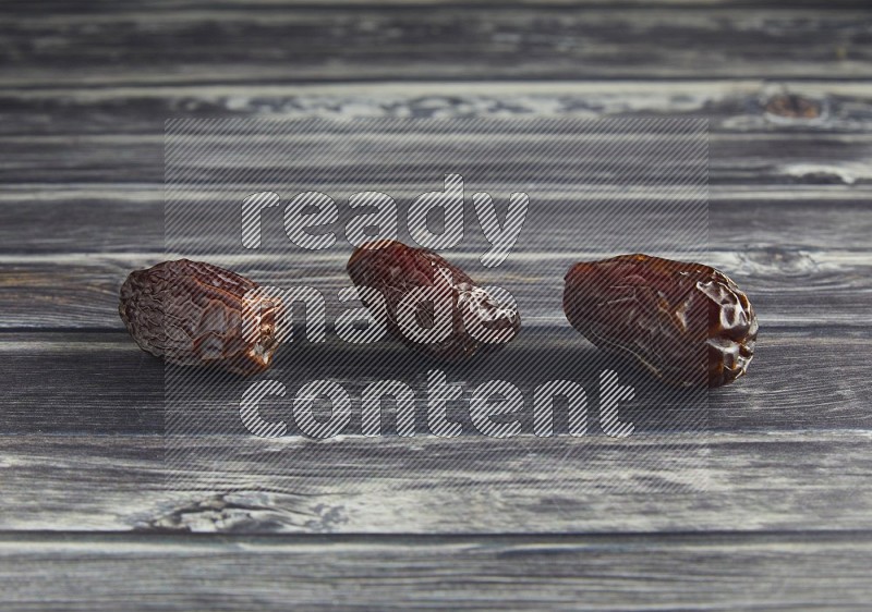 three madjoul date on a wooden grey background
